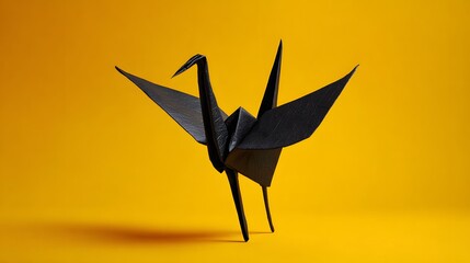 Fototapeta premium Black Origami Crane Bird on Yellow Background.