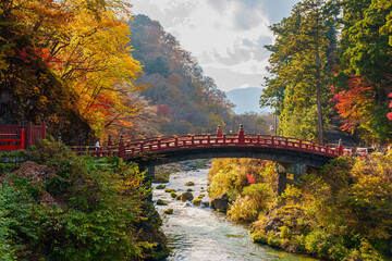 Beautiful sunlight shining on Shinkyo Bridge amid the autumn scenery in Nikko, Tochigi, Japan.
