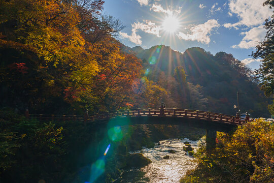 Beautiful sunlight shining on Shinkyo Bridge amid the autumn scenery in Nikko, Tochigi, Japan.