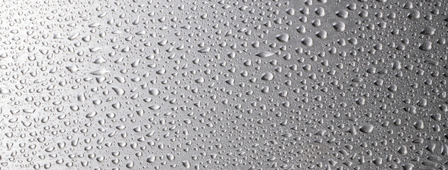 ステンレス板の上の水滴の背景テクスチャー