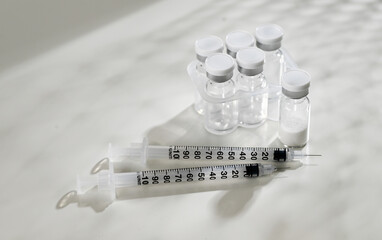 Close up of Empty Glass Vials with One Filled with Lyophilized Substance 