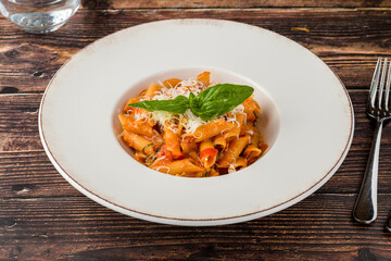Penne pasta tossed in rich tomato sauce with fresh basil
