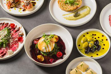 Colorful Mediterranean starters with olives, cheese, and vibrant sauces