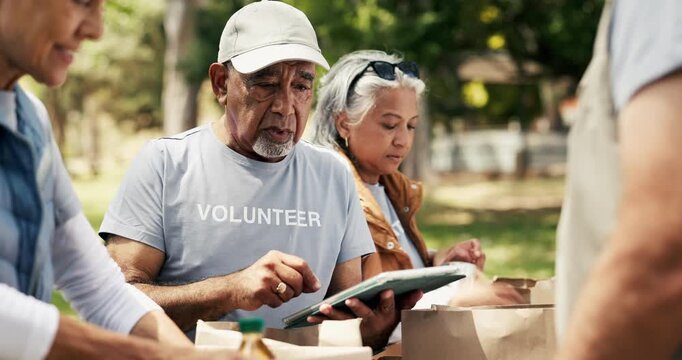 Tablet, food drive and senior volunteers in nature for charity, non profit and community outreach. Digital technology, packing and group of ngo employees with groceries distribution outdoor in park.