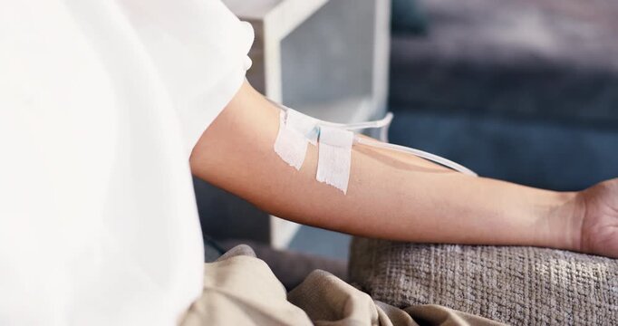 Arm, healthcare and iv with person in drip lounge for infusion benefits, recovery or wellness. Fluid, hydration and medical treatment with patient closeup in clinic for mineral or vitamin solution