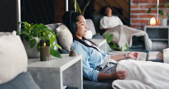 Woman, headphones or relax at drip therapy in lounge for immune health, saline solution or music. People, calm patient and audio with IV vitamin c for wellness benefits, mineral infusion or hydration
