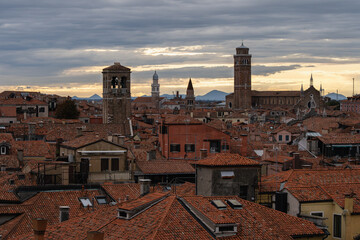 Scenic View of Venice Rooftops and Bell Towers at Sunset with Distant Mountains