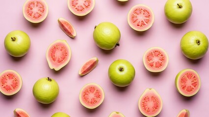 Vibrant pink backdrop featuring fresh green guavas, halved and whole fruits