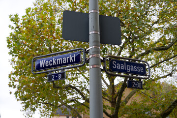 Weckmarkt and Saalgasse blue and white colored metal street name signs at German city of Frankfurt on a cloudy autumn day. Photo taken November 3rd, 2025, Frankfurt am Main, Germany.