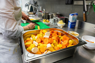 The Restaurant workers at the kitchen prepare the vegetables for dinner time