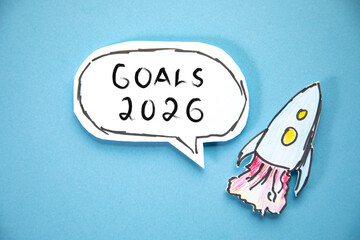 goals 2026 text on paper with rocket