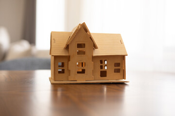 wooden house model on table