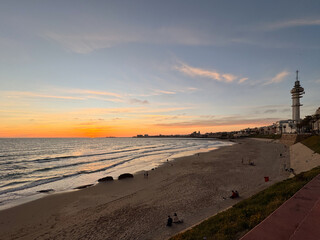 Cadiz, Spain - April 16, 2025: Typical view of the Bay of Cadiz with the sea in the foreground in the city of Cadiz, Spain