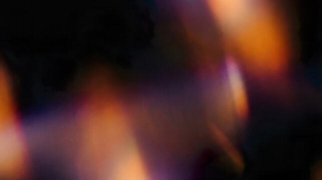 Abstract light leak overlay effect glowing softly against a black background.