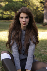  beautiful young slavic woman with long dark natural hair in elegant clothes