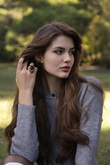  beautiful young slavic woman with long dark natural hair in elegant clothes