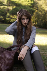  beautiful young slavic woman with long dark natural hair in elegant clothes