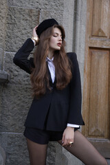  beautiful young slavic woman with long dark natural hair in elegant clothes