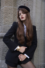  beautiful young slavic woman with long dark natural hair in elegant clothes