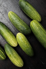 Fresh cucumbers on a wooden table make a full frame 