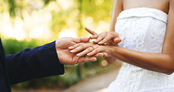 Wedding, ring and hands of couple in park for marriage, love and commitment for celebration. Affection, outdoor and bride and groom with jewelry for bonding, relationship and romantic event together