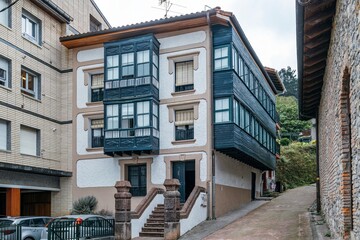 Obraz premium Traditional Northern Residential Building With Dark Wooden Bay Windows and Balconies