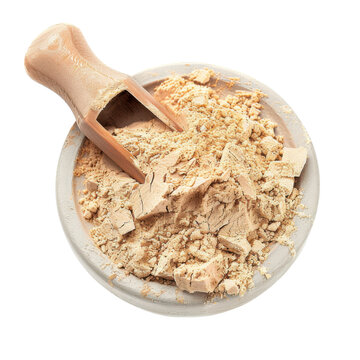 Macca Powder in a Bowl: Captured from an overhead perspective, this image showcases a wooden bowl filled with beige macca powder and a wooden scoop. Embodying health and wellness.