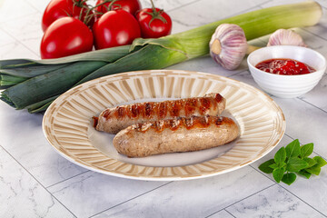 Grilled pork sausages served tomato sauce