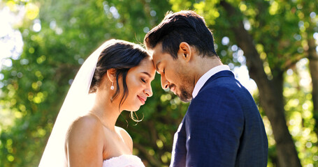 Fototapeta premium Wedding, couple and love in park with smile, support and celebration for bridal union or marriage. Happy bride, groom and people in garden with trust for life partner, commitment or together outdoor