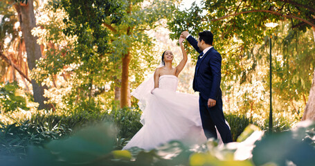 Couple, wedding and dance at park, celebration and holding hands with smile, love and milestone. People, marriage and excited with commitment, relationship or happy outdoor with rhythm for event