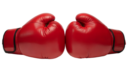 Two bright red leather boxing gloves facing each other on a stark ready for a fight