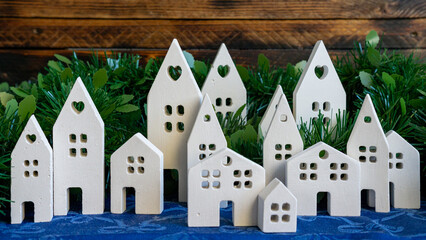 White ceramic village panorama with winter greenery.