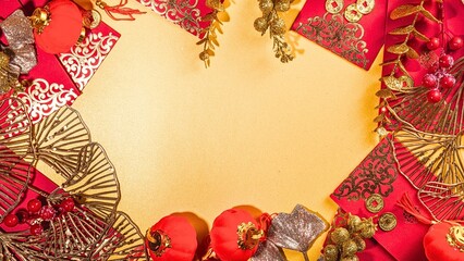 Festive frame with red envelopes and golden decorations for Chinese New Year celebration on a yellow background.