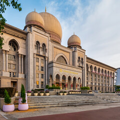 Istana Kehakiman, Palace of Justice, a grand building with Islamic-inspired domes and arches, under a blue sky in Putrajaya, Malaysia © Khaled El-Adawi