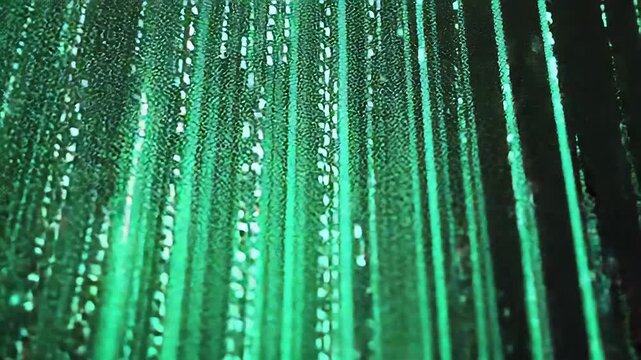 Luminous green and yellow glowing binary code elements rapidly flowing across a dark digital background, representing data transfer and network communication in cybersecurity and virtual reality