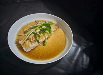 chicken noodle soup Tim Ikan,Steamed snapper fish with soybean sauce in a plate,Fish in soysauce