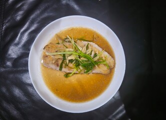 vegetable soup with bread Tim Ikan,Steamed snapper fish with soybean sauce in a plate,Fish in soysauce
