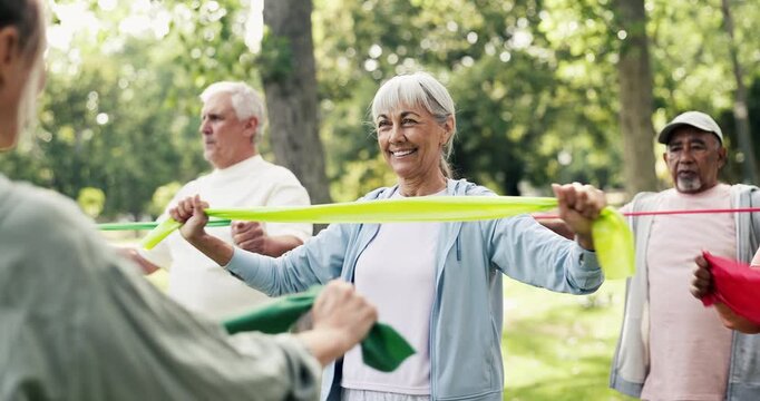 Elderly group, coach and resistance band with exercise in nature for workout class or training. Senior people, fitness or stretching with personal trainer for flexibility, health or wellness in park