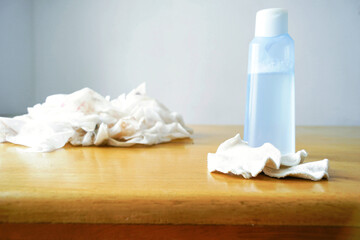 Used disposable cleansing wipes with makeup remover bottle and reusable cotton pads. Symbolizes beauty waste awareness, sustainable skincare alternatives, and eco-conscious product choices.