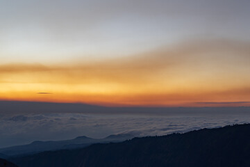 Mountain silhouette with sunset sky cloud inversion offering serene scenic natural beauty