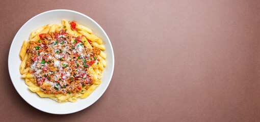 Pasta with bolognese sauce and cheese. Italian cuisine. Traditional recipe.