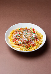 Pasta with bolognese sauce and cheese. Italian cuisine. Traditional recipe.