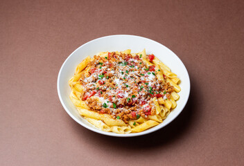 Pasta with bolognese sauce and cheese. Italian cuisine. Traditional recipe.