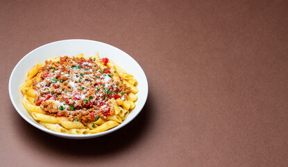 Pasta with bolognese sauce and cheese. Italian cuisine. Traditional recipe.