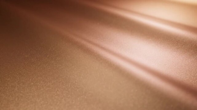 A warm, golden-toned surface with soft reflections, smooth texture, and abstract, gradient lighting with glow