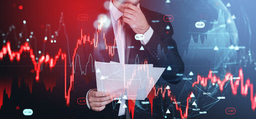 Businessman analyzing forex and crypto market data with holograp