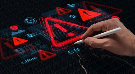 Hand using pen to interact with digital warning interface featuring red alert icons on futuristic tech screen background concept for cybersecurity issue..