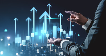 Businessman interacting with rising stock market chart concept on futuristic background with glowing blue arrows and financial candlestick graphs.