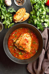 Baked chicken with tomato gravy and herbs