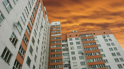 Building with orange sky at sunset in urban area during evening hours